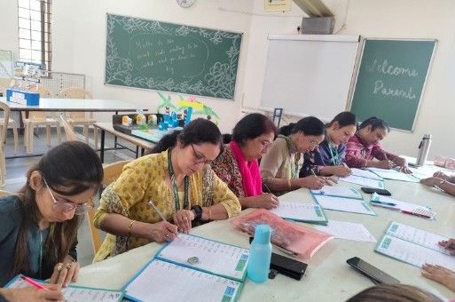 Teachers practising handwriting techniques during training